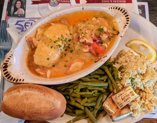 seafood dish with roll, green beans, rice