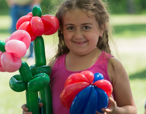 Girl with Balloon Animals Photo