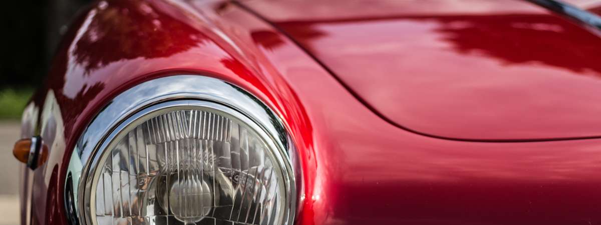 closeup of the front of a red classic car