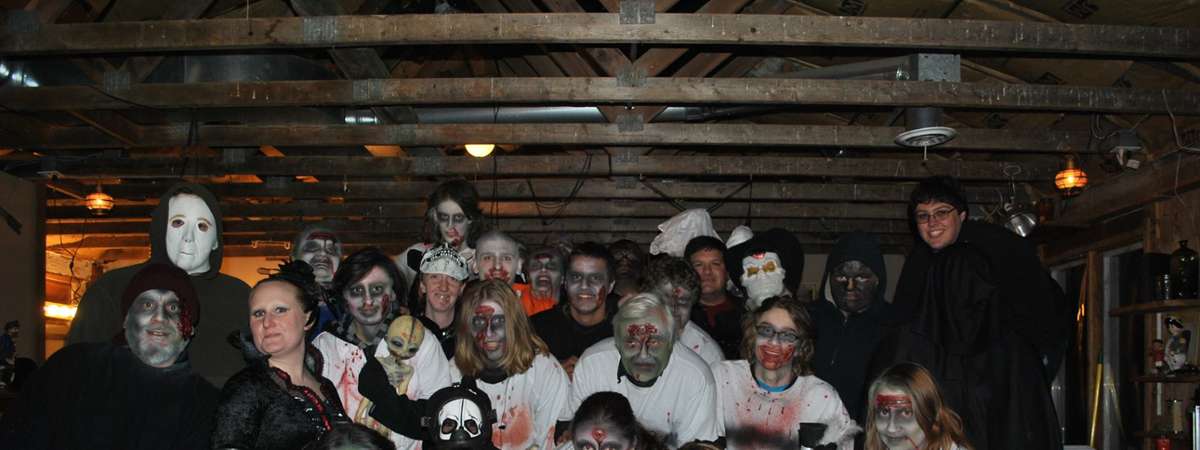 people dressed in a spooky haunted barn