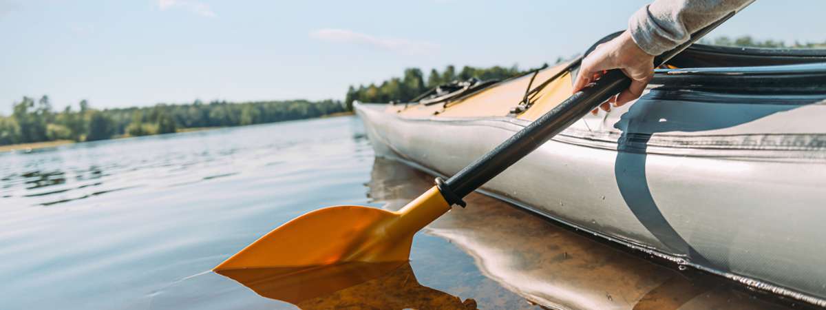 closeup of canoe paddle in the water