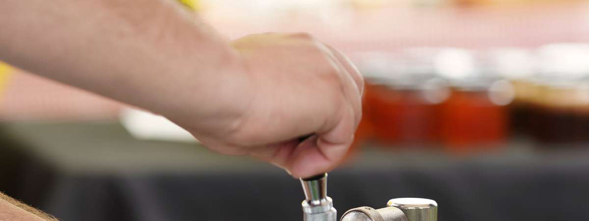 vendor pouring beer at the adirondack wine and food festival