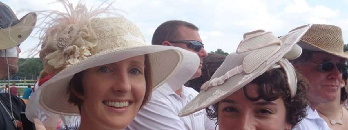 two women wearing fancy hats
