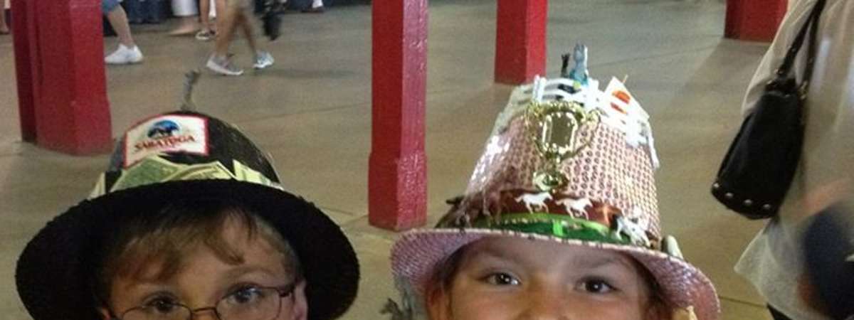 two kids with saratoga race course themed hats