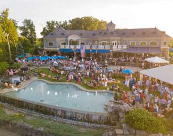 crowd on the patio at prime at saratoga national