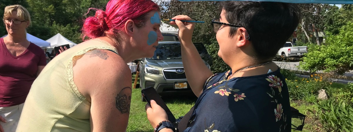 woman gets face painted