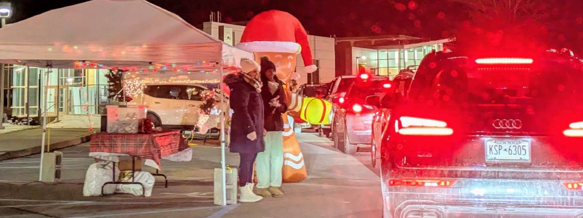 line of cars and people at candy cane lane