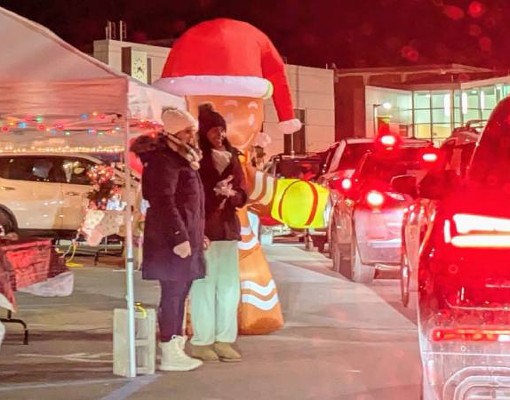 line of cars and people at candy cane lane