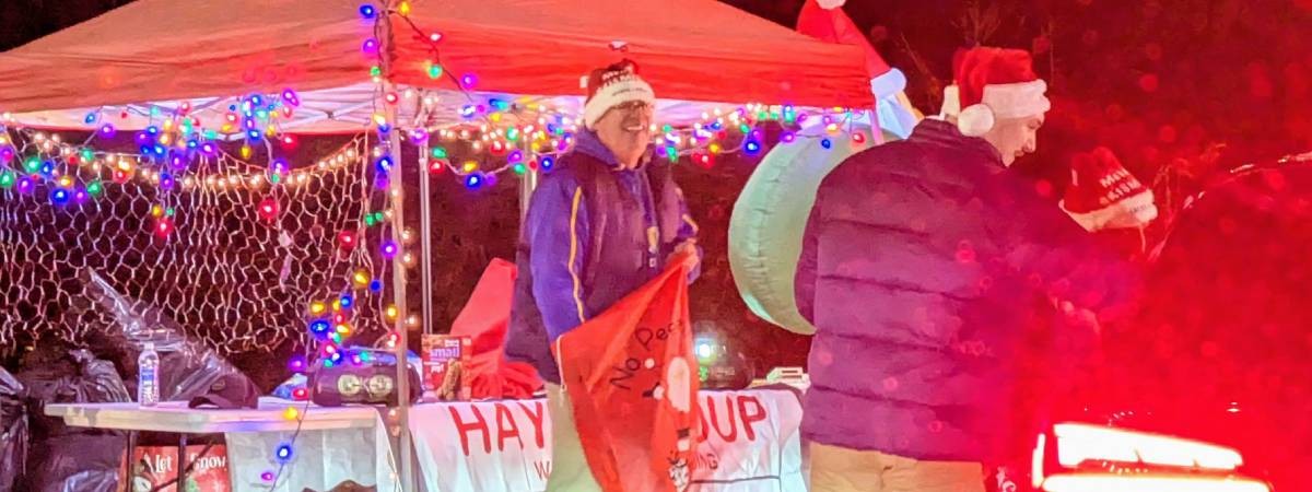 man ready to give out candy at candy cane lane