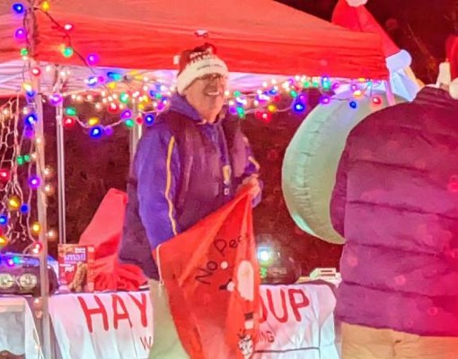 man ready to give out candy at candy cane lane