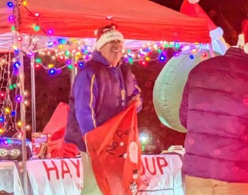 man ready to give out candy at candy cane lane