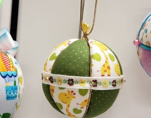 three christmas tree ornaments on display