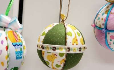 three christmas tree ornaments on display