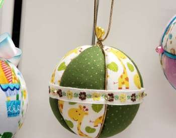 three christmas tree ornaments on display