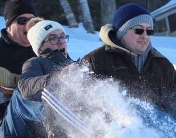 four people on a sleigh ride