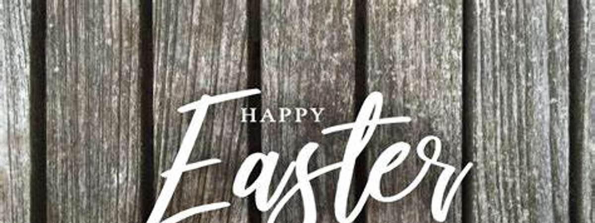 happy easter text over a brown fence with colored eggs at the bottom