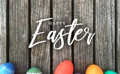 happy easter text over a brown fence with colored eggs at the bottom