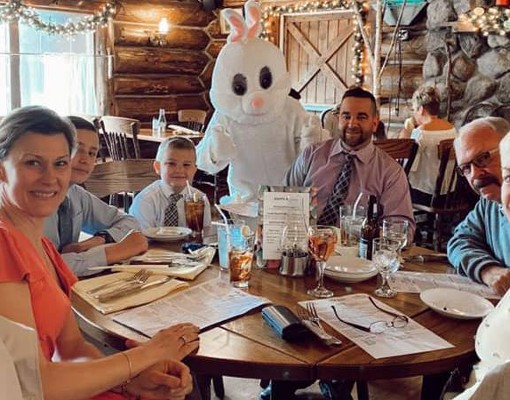 people at easter dinner at log jam with easter bunny