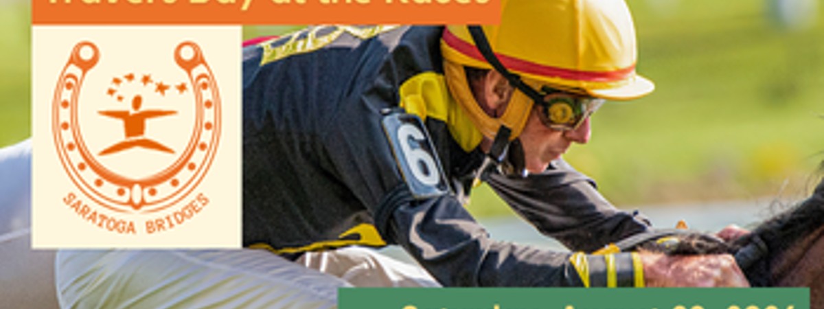 A jockey wearing a yellow hat riding a horse in a race with the Saratoga Bridges logo surrounded by a horseshoe.