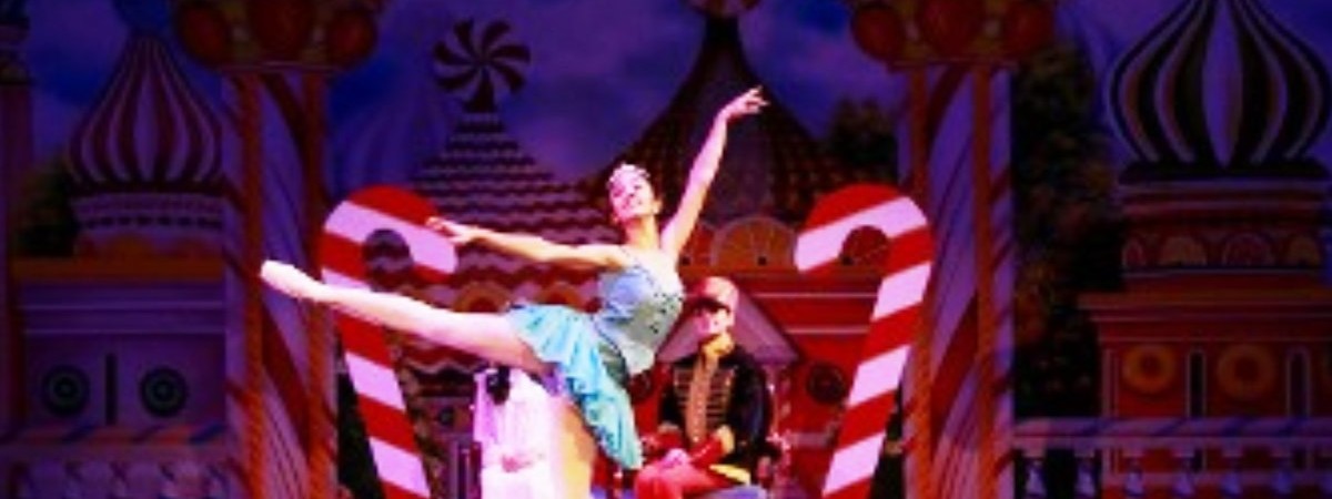 girl performing ballet dance in front of candy canes