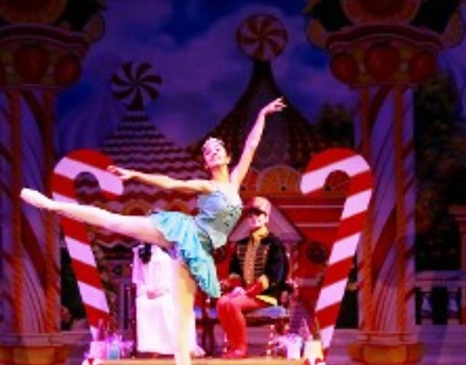 girl performing ballet dance in front of candy canes