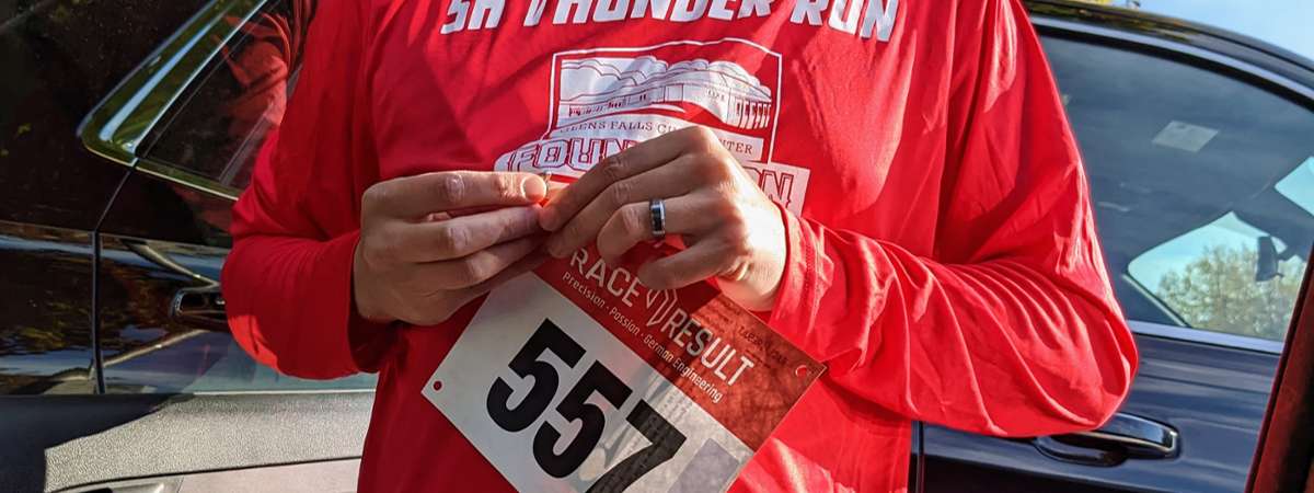 man in running shirt with tracking bib