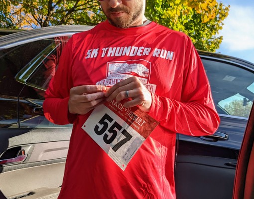 man in running shirt with tracking bib