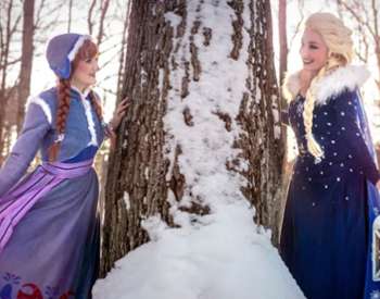 snow sisters by a tree