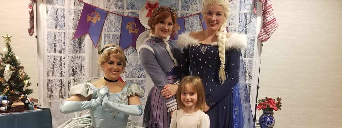 little girl poses with princesses