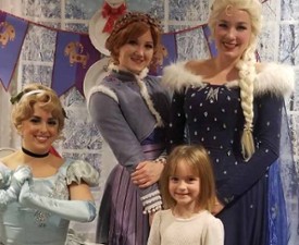 little girl poses with princesses