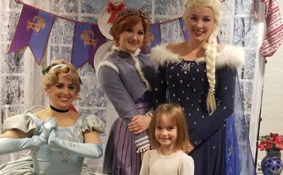 little girl poses with princesses