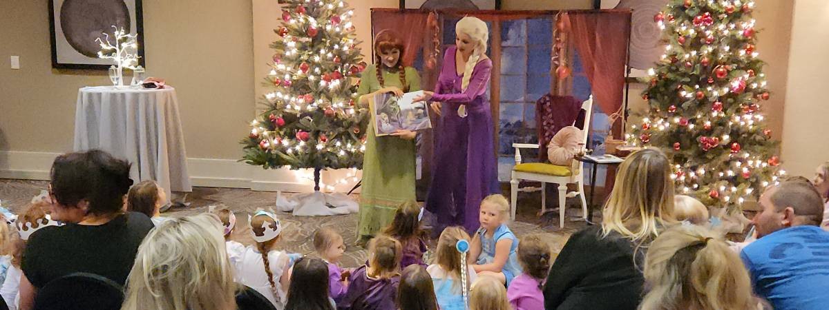 snow sisters reading book to kids at show