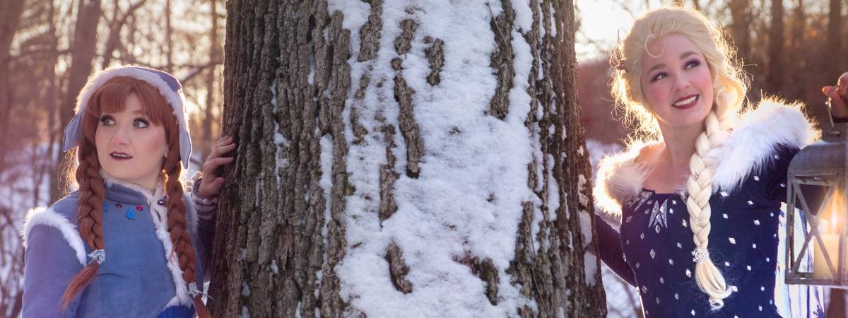 snow sisters by a tree