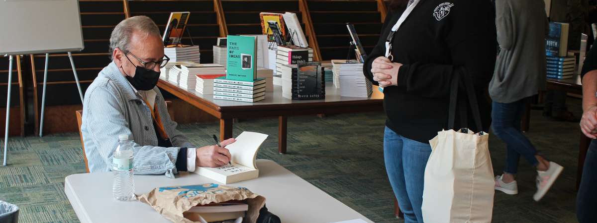 person at a book signing table