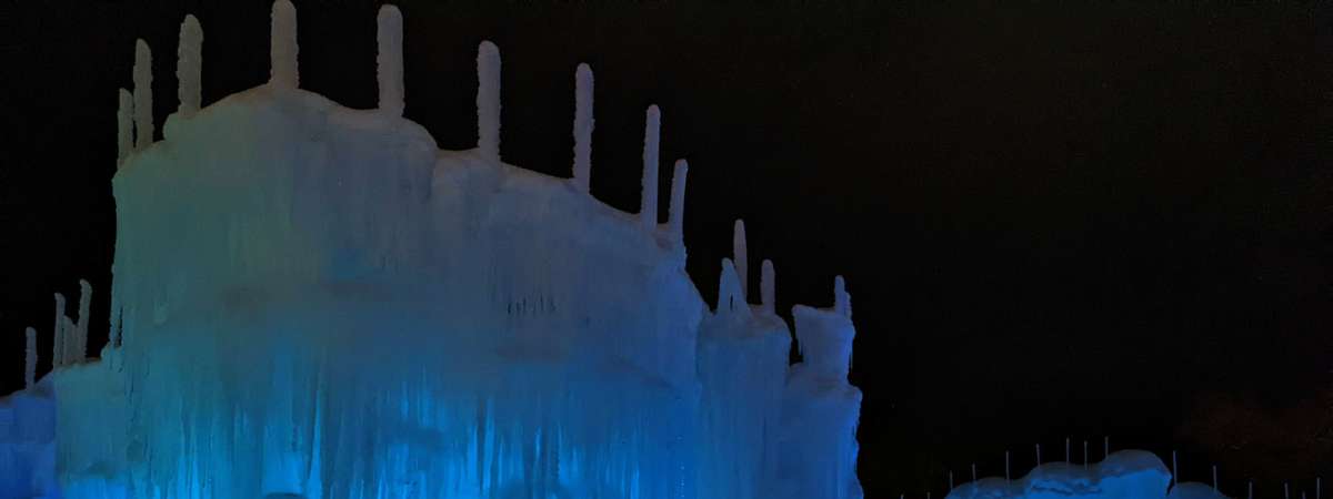 ice castles lit up blue at night