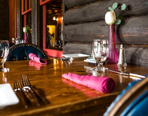 table set with pink napkins and pink vase