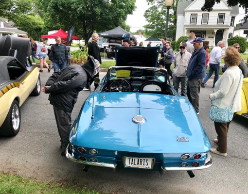 people at an outdoor car show