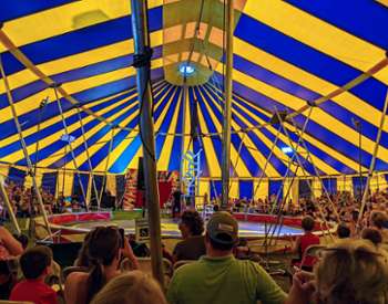man on chair tower in circus
