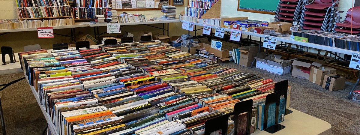 stacks of books on white plastic tables