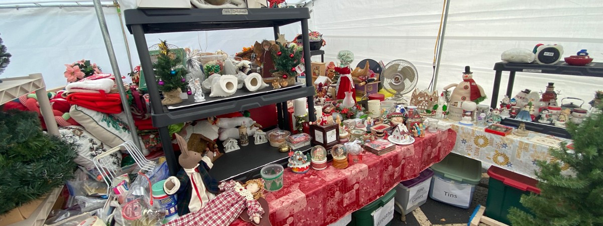 a table full of christmas decorations in a tent