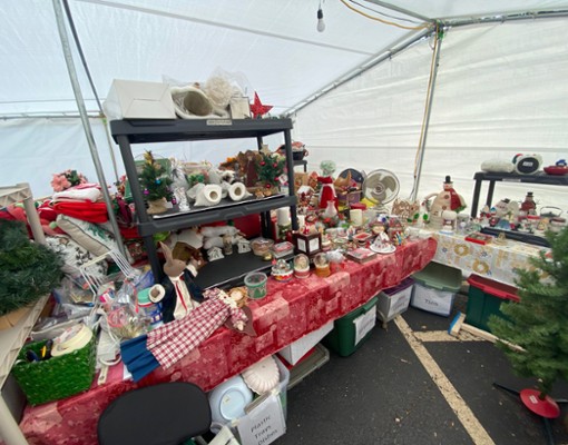 a table full of christmas decorations in a tent