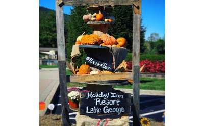 stacked pumpkins with Harvest Bar sign