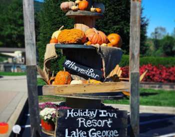 stacked pumpkins with Harvest Bar sign