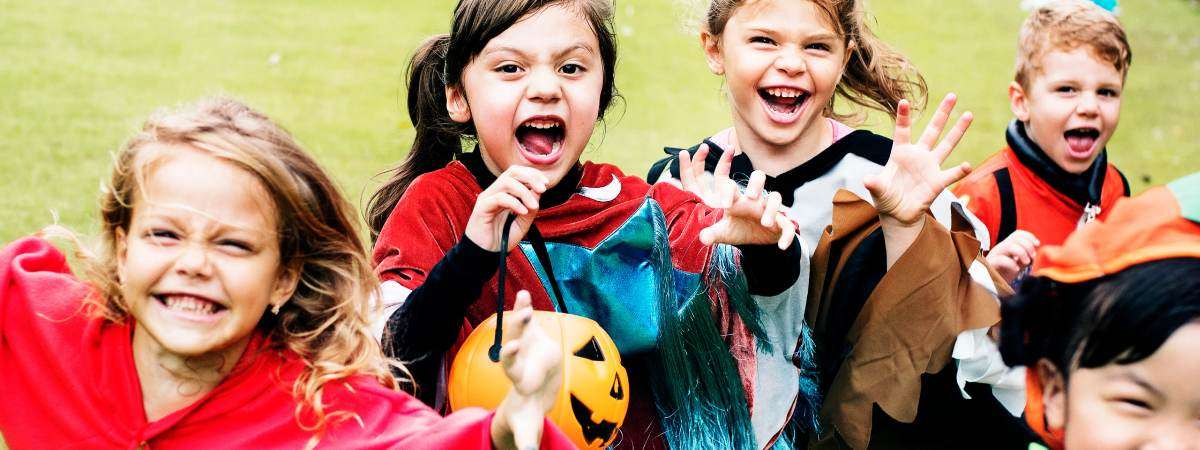 happy kids in costume trick-or-treating