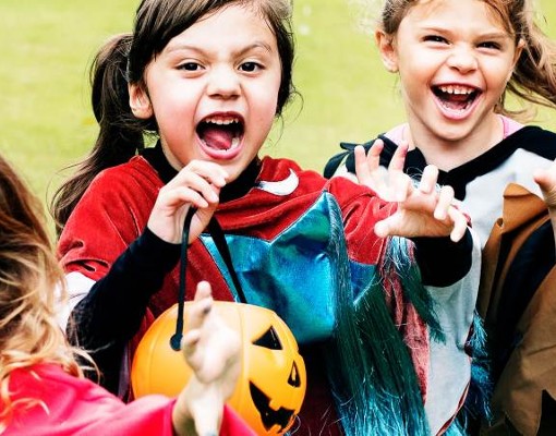 happy kids in costume trick-or-treating