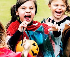 happy kids in costume trick-or-treating