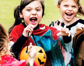 happy kids in costume trick-or-treating