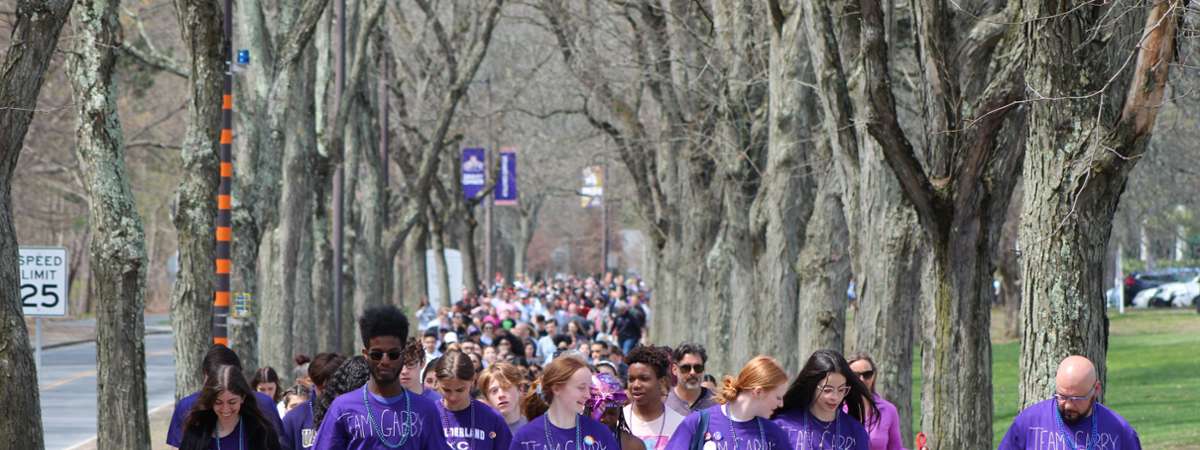 Large group of 670 walkers behind a banner with the logo for the American Foundation for Suicide Prevention.