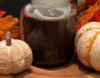 small pumpkins on display by cocktail in mason jar