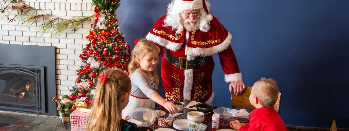 santa talking to kids at a table